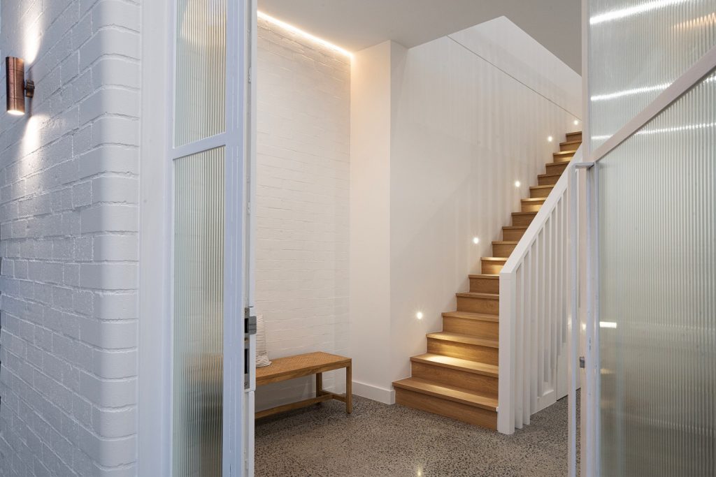 Home entryway with staircase and recessed lighting
