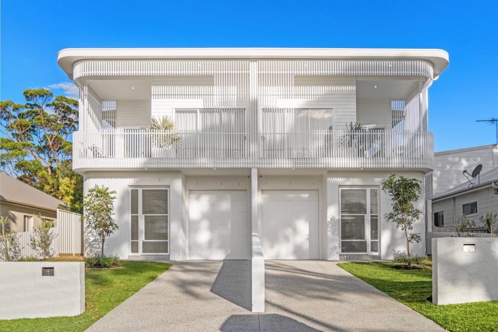 Modern duplex exterior with residential lighting