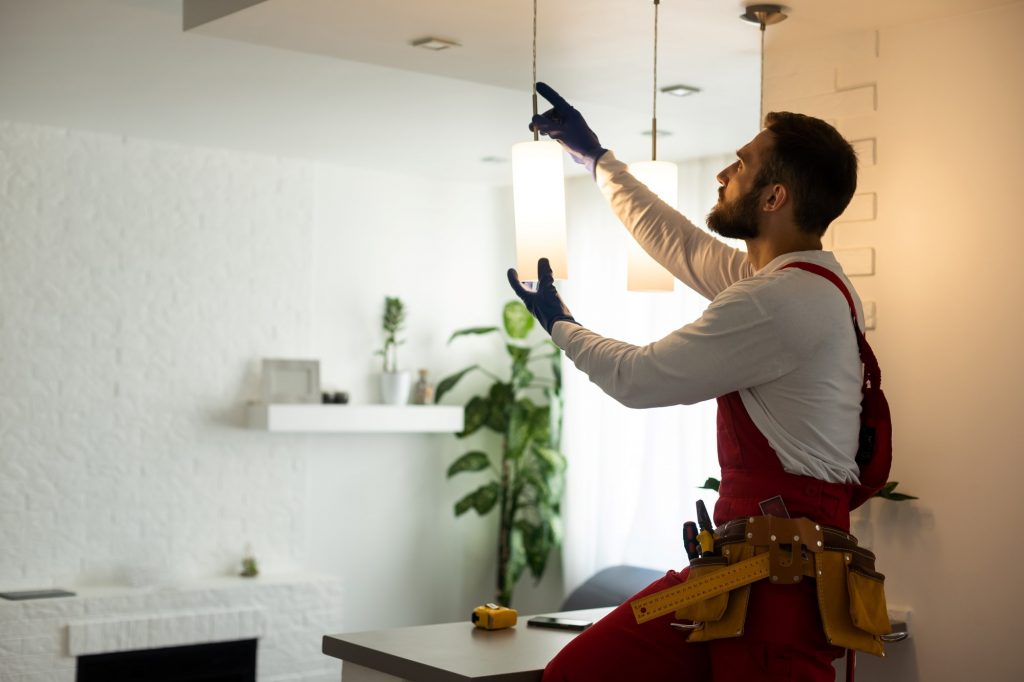 Electrician installing a light fixture