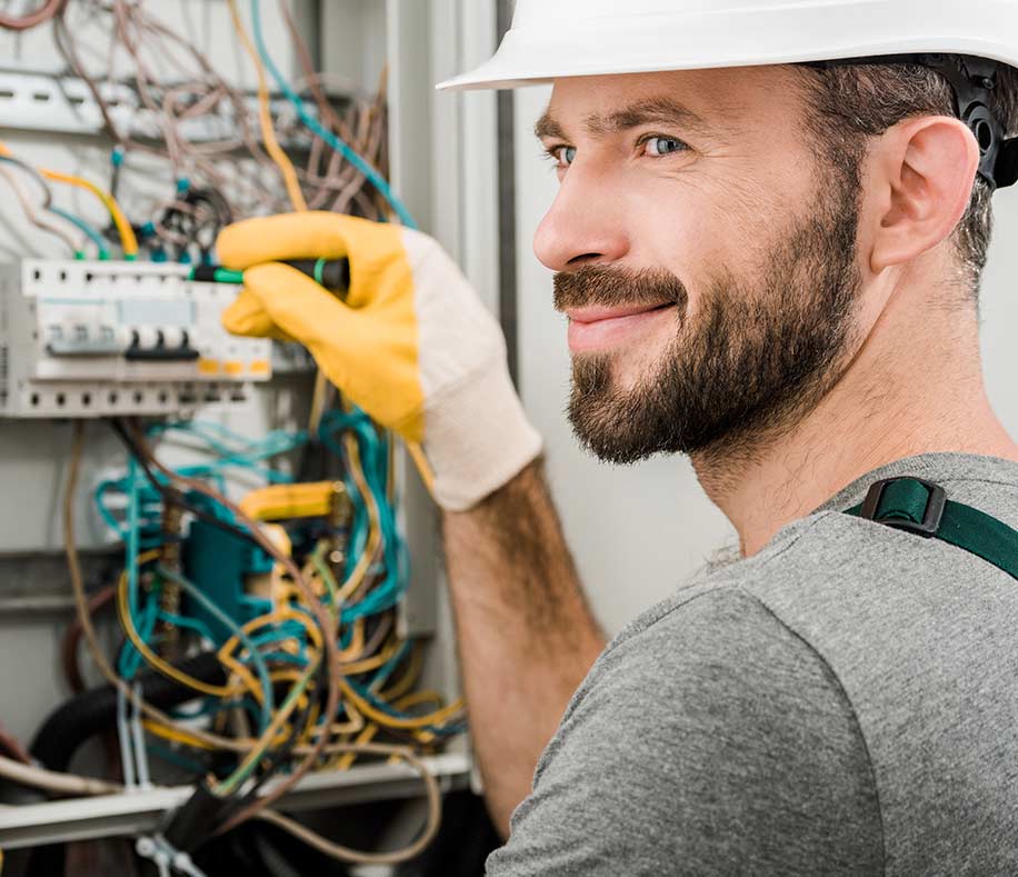Electrician working on commercial switchboard