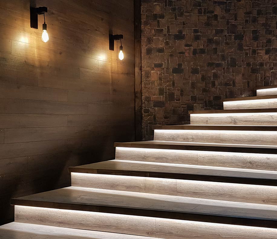 Wide staircase with Edison sconces in commercial venue