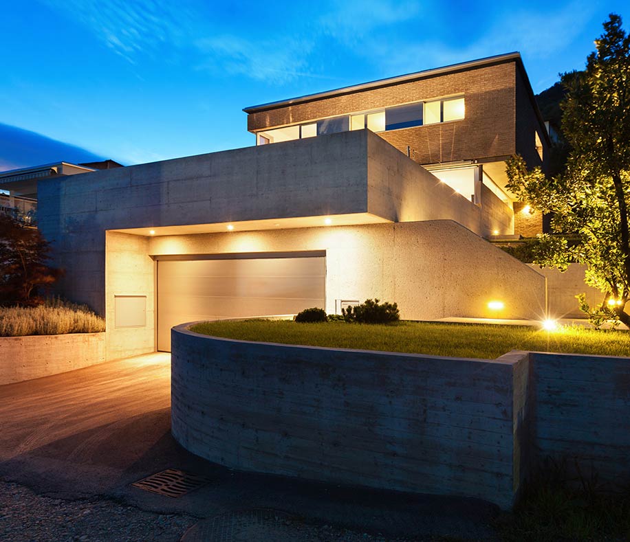 Modern home exterior with architectural lighting at dusk