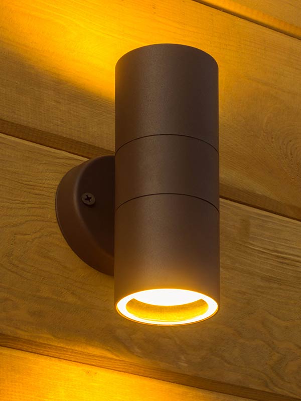 Cylindrical wall sconce on exterior timber cladding
