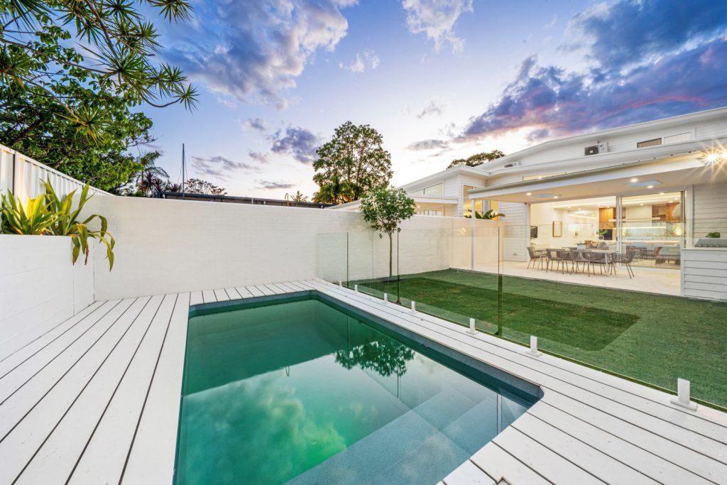 Premium home lighting by Randwick Electrical — pool and outdoor illumination at dusk